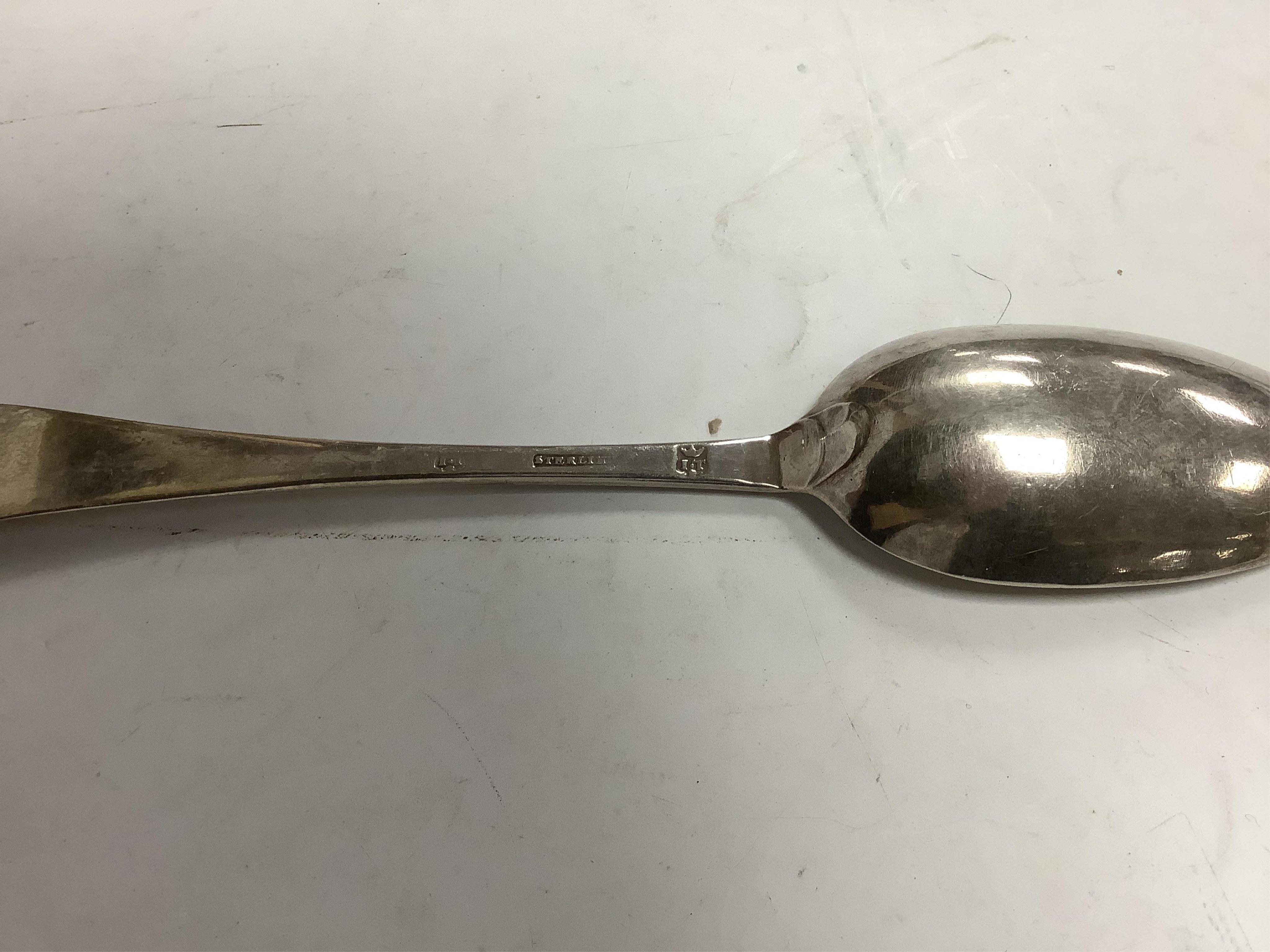 An 18th century Irish? provincial silver Hanoverian pattern tablespoon, maker's mark stamped twice 'I.T with crown above and mullet below' and 'Sterling', 20.9cm, together with eight assorted 18th century silver rat tail